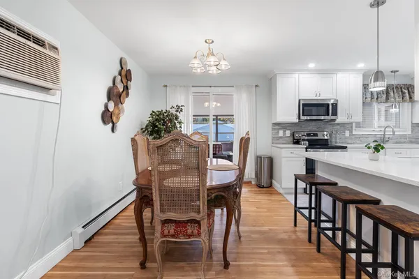 a kitchen with stainless steel appliances furniture refrigerator and wooden floor
