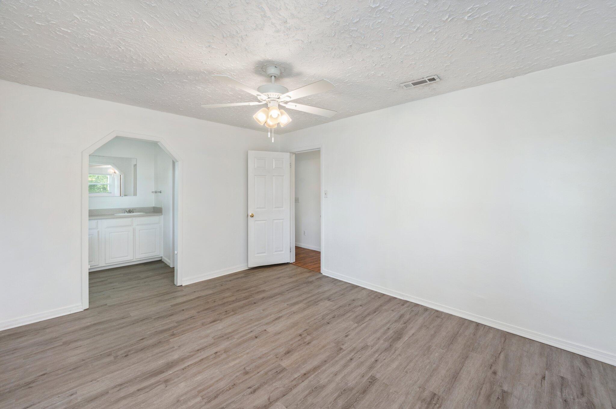 1099 Highway 2 Westville, FL 32464 - Photo 19 of 34 an empty room with a bathroom and a ceiling fan