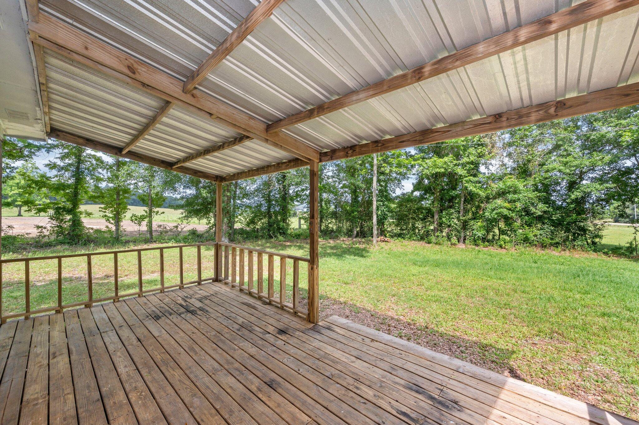 1099 Highway 2 Westville, FL 32464 - Photo 29 of 34 a view of a backyard with wooden floor