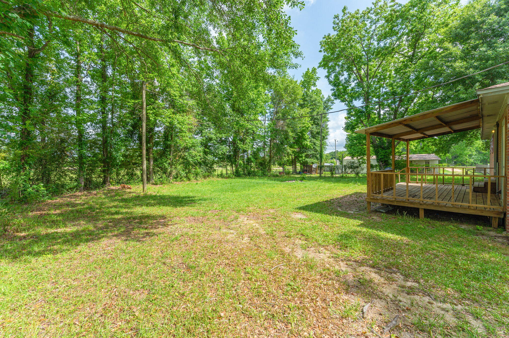 1099 Highway 2 Westville, FL 32464 - Photo 31 of 34 a view of a backyard with a garden and trees