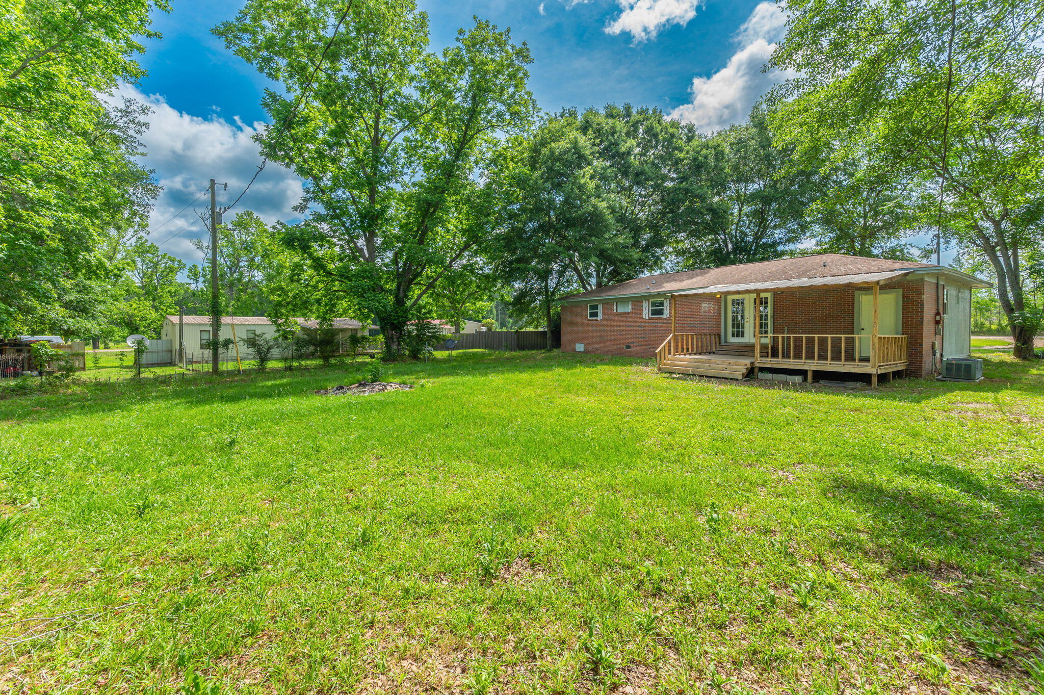 1099 Highway 2 Westville, FL 32464 - Photo 32 of 34 a view of a house with a big yard and large trees