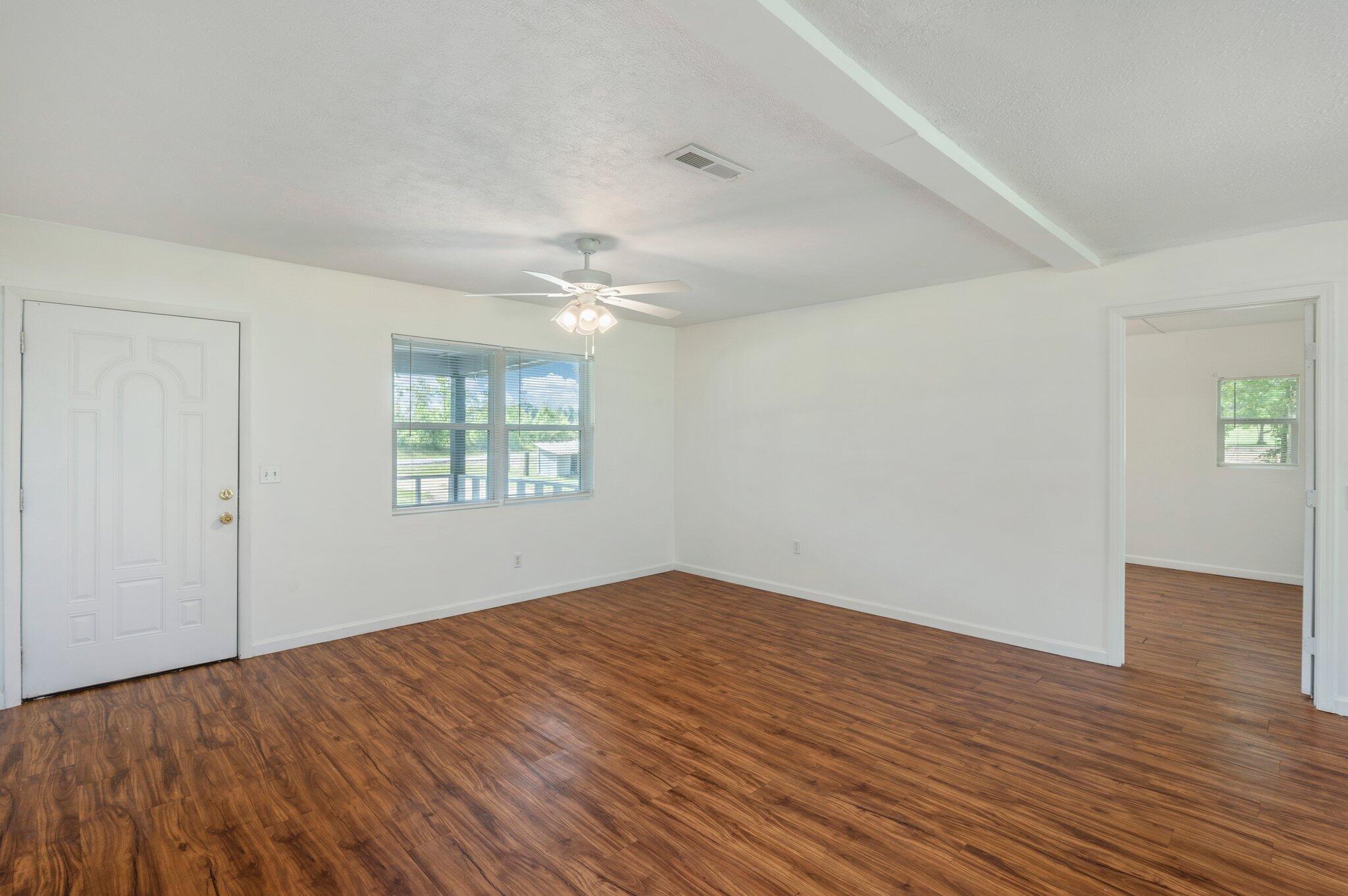1099 Highway 2 Westville, FL 32464 - Photo 8 of 34 wooden floor in an empty room with a window