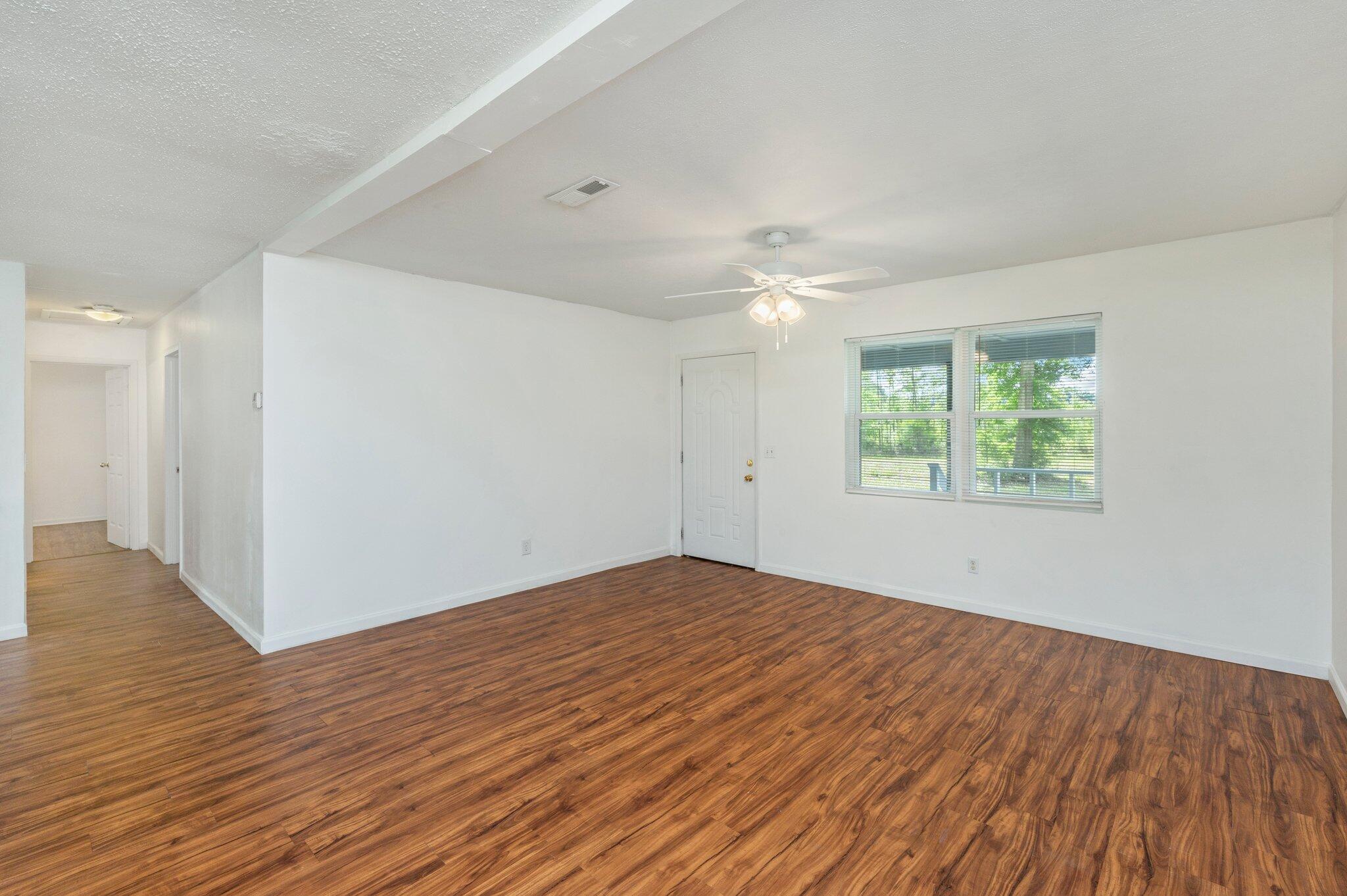 1099 Highway 2 Westville, FL 32464 - Photo 9 of 34 a view of an empty room with wooden floor and a window