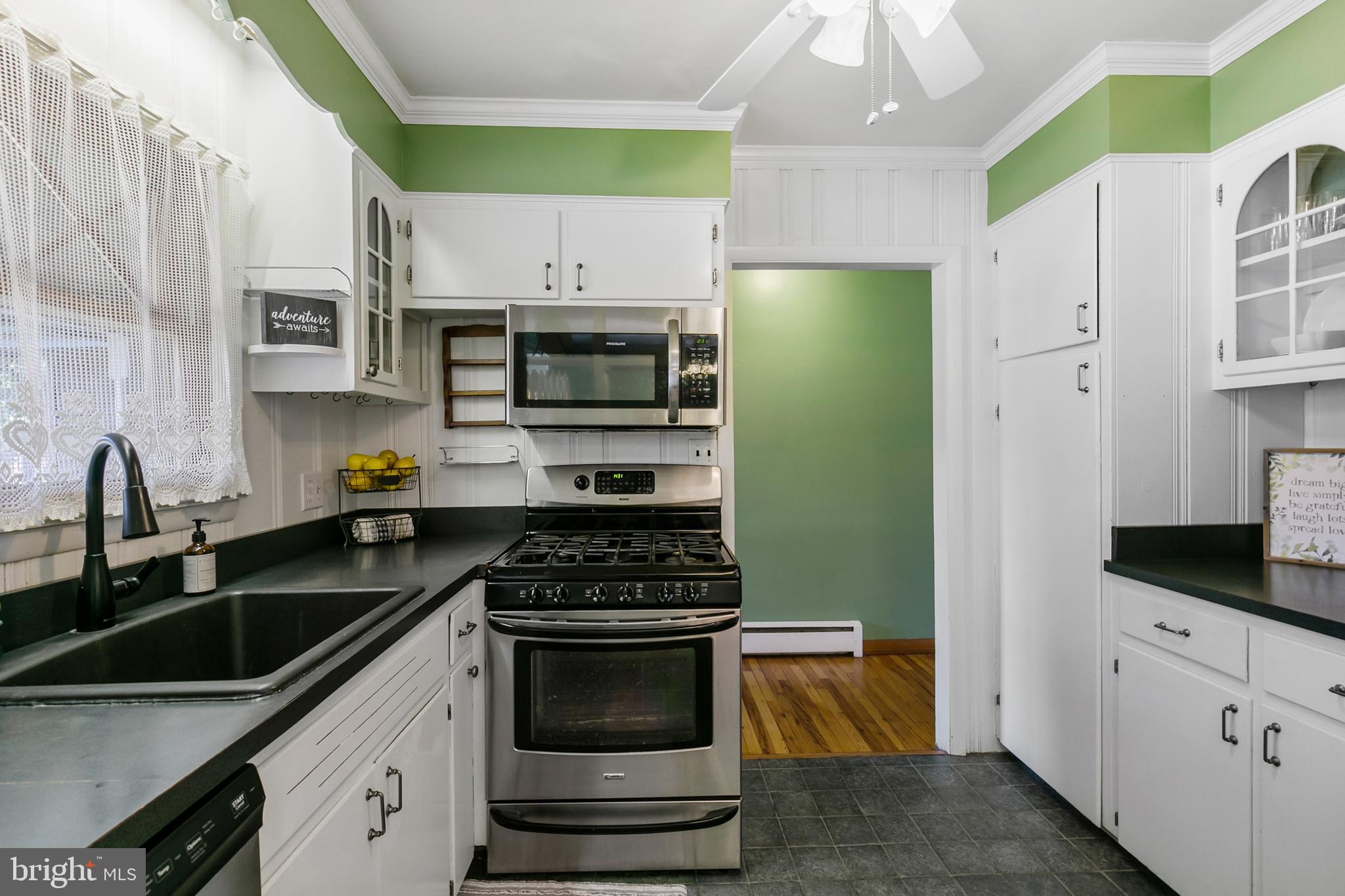 1358 Stokes Road Medford, NJ 08055 - Photo 14 of 36 a kitchen with stainless steel appliances a stove a microwave a sink and cabinets
