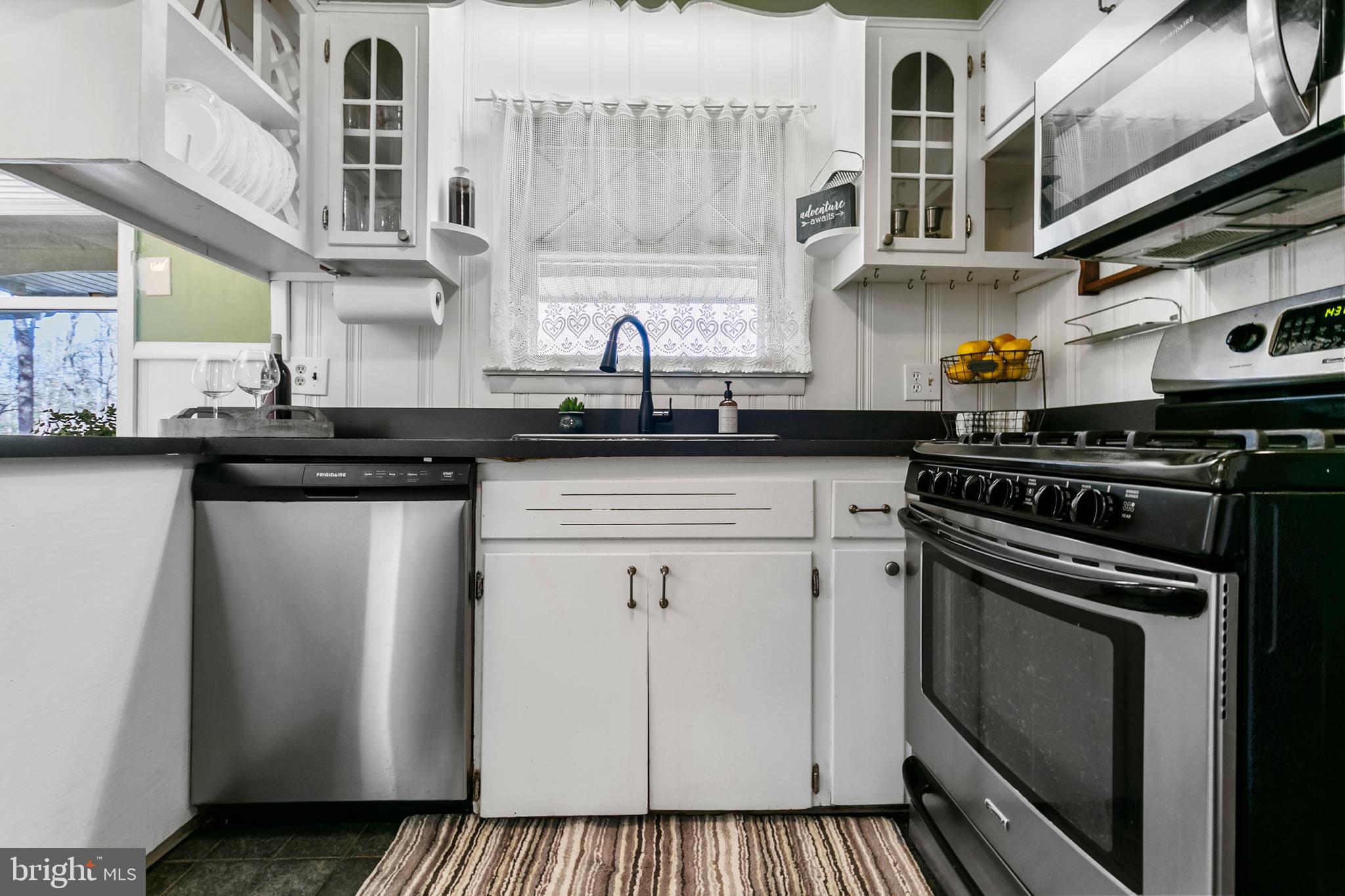 1358 Stokes Road Medford, NJ 08055 - Photo 15 of 36 a kitchen with stainless steel appliances a sink a stove and cabinets