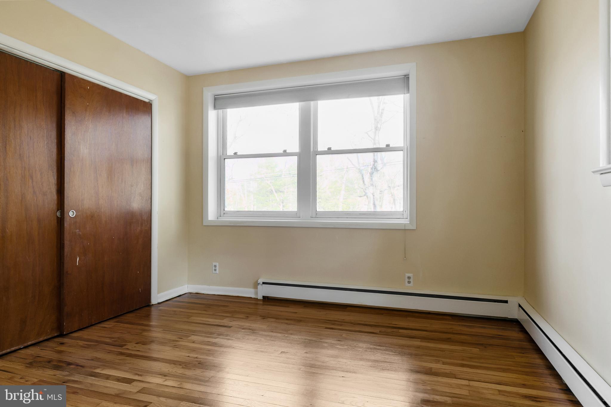 1358 Stokes Road Medford, NJ 08055 - Photo 18 of 36 an empty room with wooden floor and windows