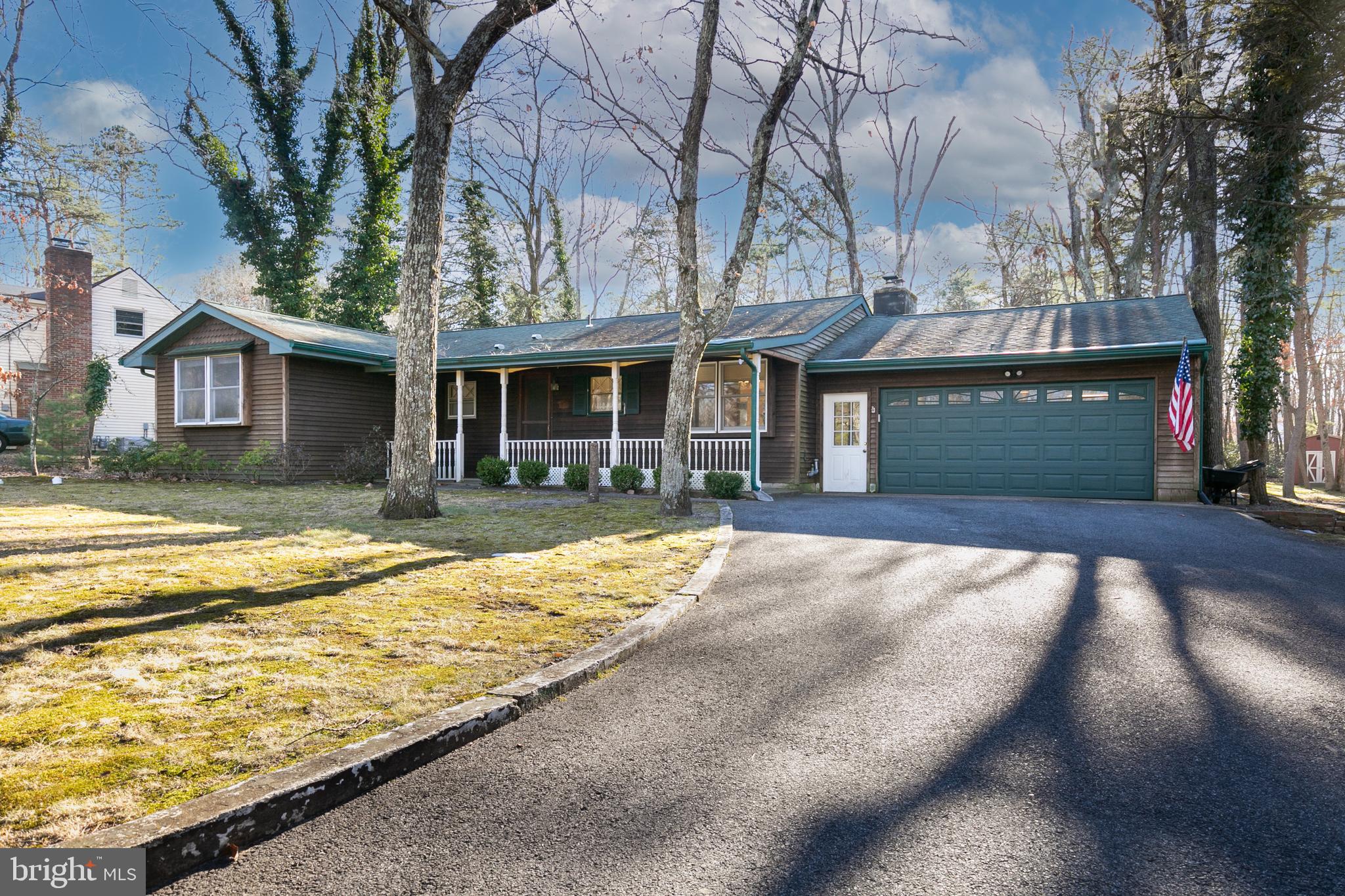 1358 Stokes Road Medford, NJ 08055 - Photo 2 of 36 a view of pool with brick walls plants and large tree