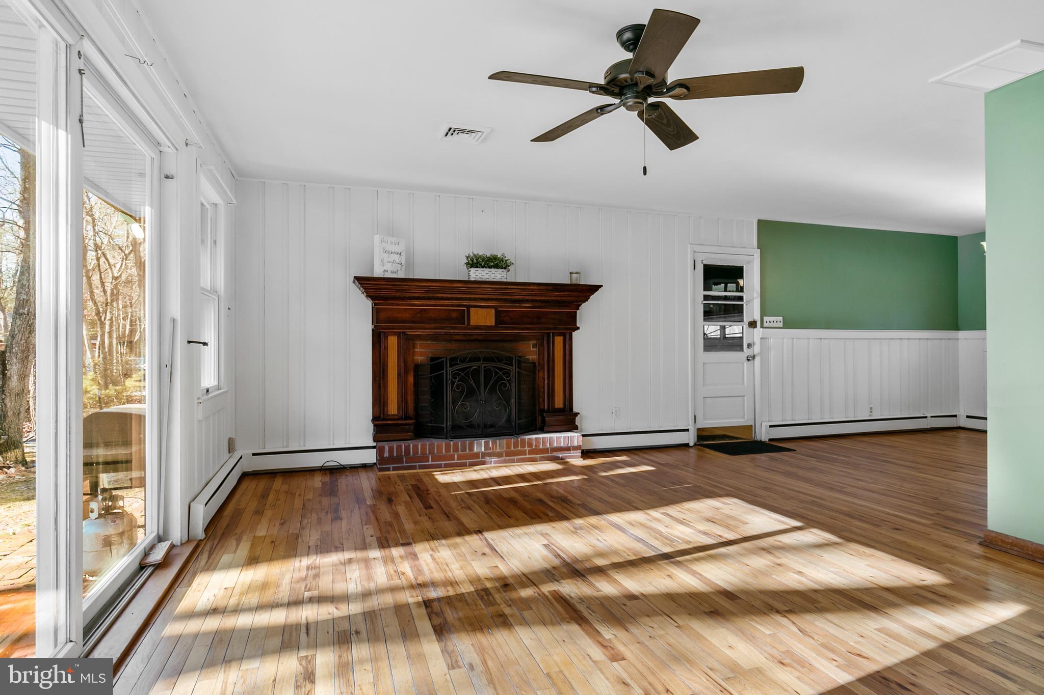 1358 Stokes Road Medford, NJ 08055 - Photo 8 of 36 a view of empty room with wooden floor and fan