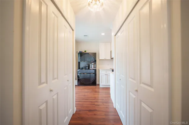 a view of a kitchen with refrigerator and a stove top oven
