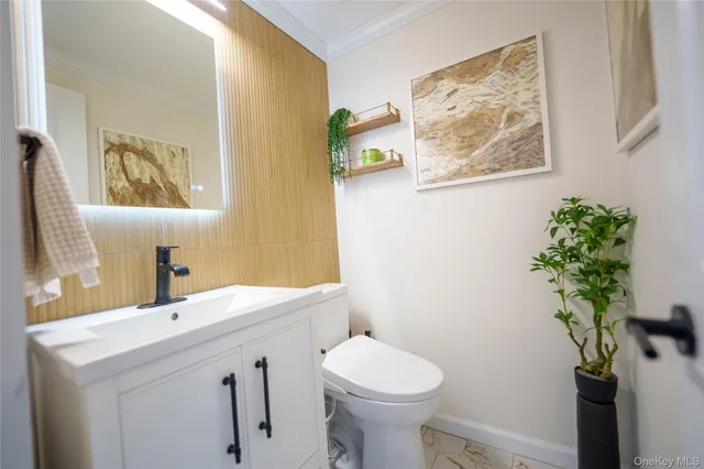 a bathroom with a sink mirror and toilet