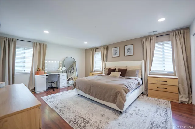 a bed room with a bed window and a dresser