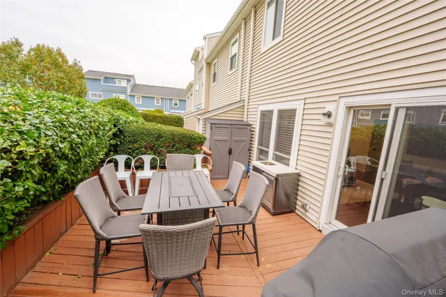a view of a patio with table and chairs and wooden floor