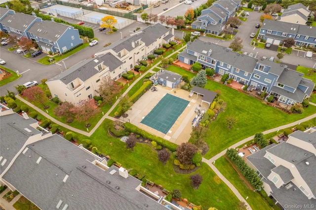 an aerial view of a tennis ground and a large pool