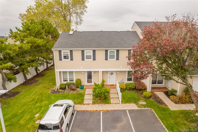 a view of a house with a chairs in patio