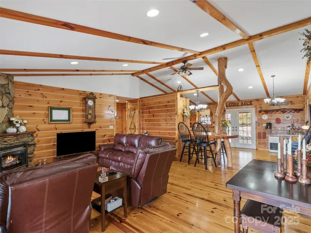 a spacious bedroom with a bed and wooden floor
