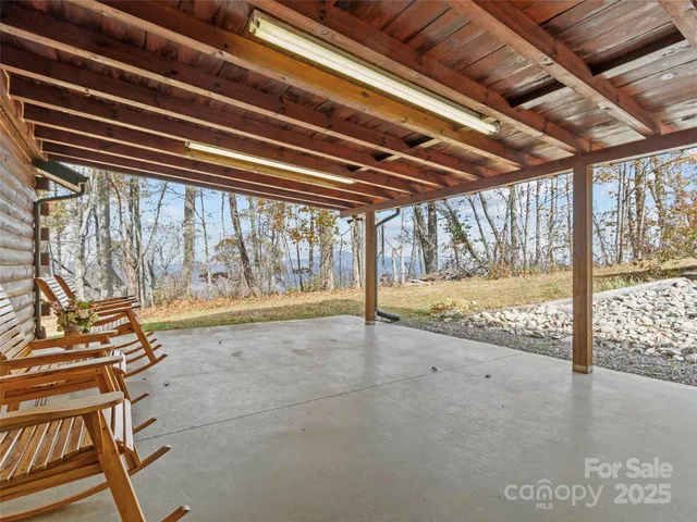 a backyard of a house with table and chairs