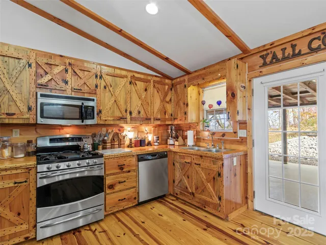 a view of a dining room with furniture wooden floor and a chandelier