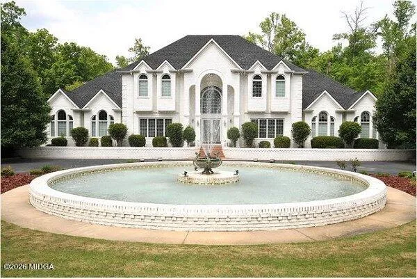 a front view of a house with a swimming pool