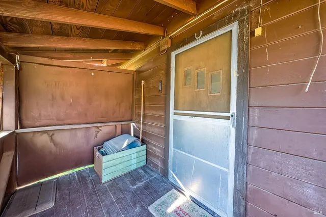 an empty room with a fireplace and a ceiling fan