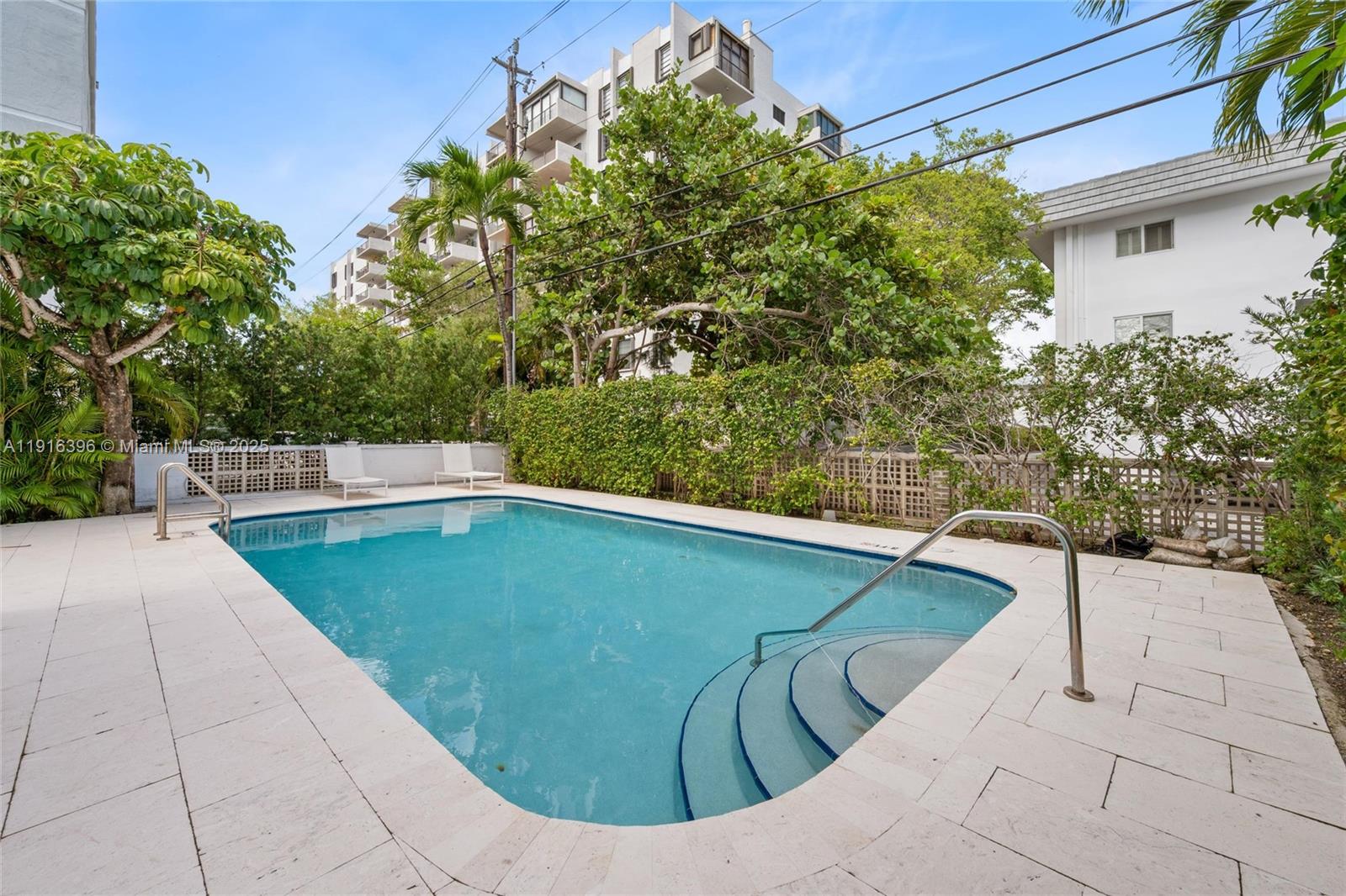 155 Sunrise Drive, Unit 4B Key Biscayne, FL 33149 - Photo 11 of 18 a view of a swimming pool with a patio