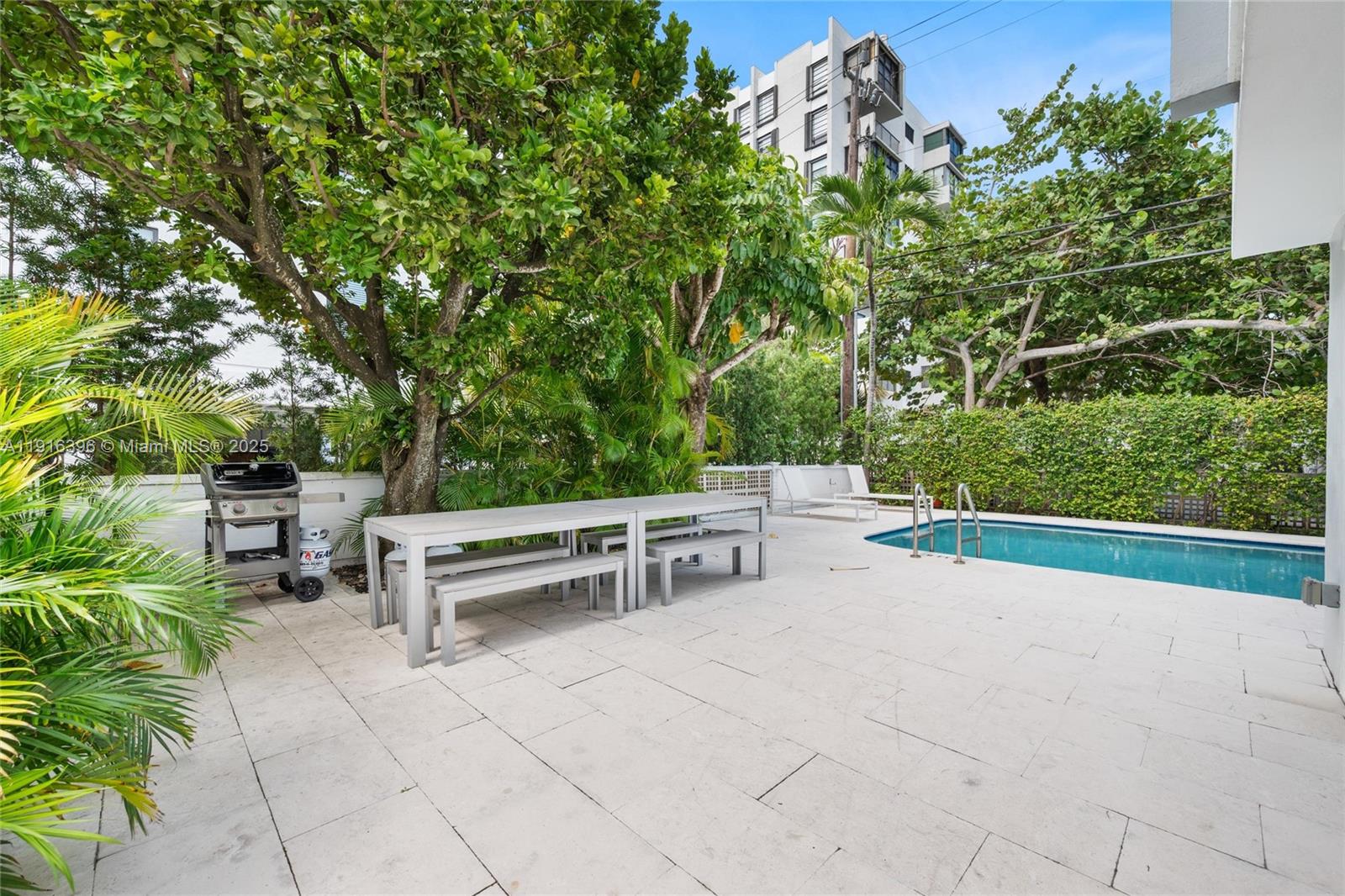 155 Sunrise Drive, Unit 4B Key Biscayne, FL 33149 - Photo 12 of 18 a view of backyard with seating and green space