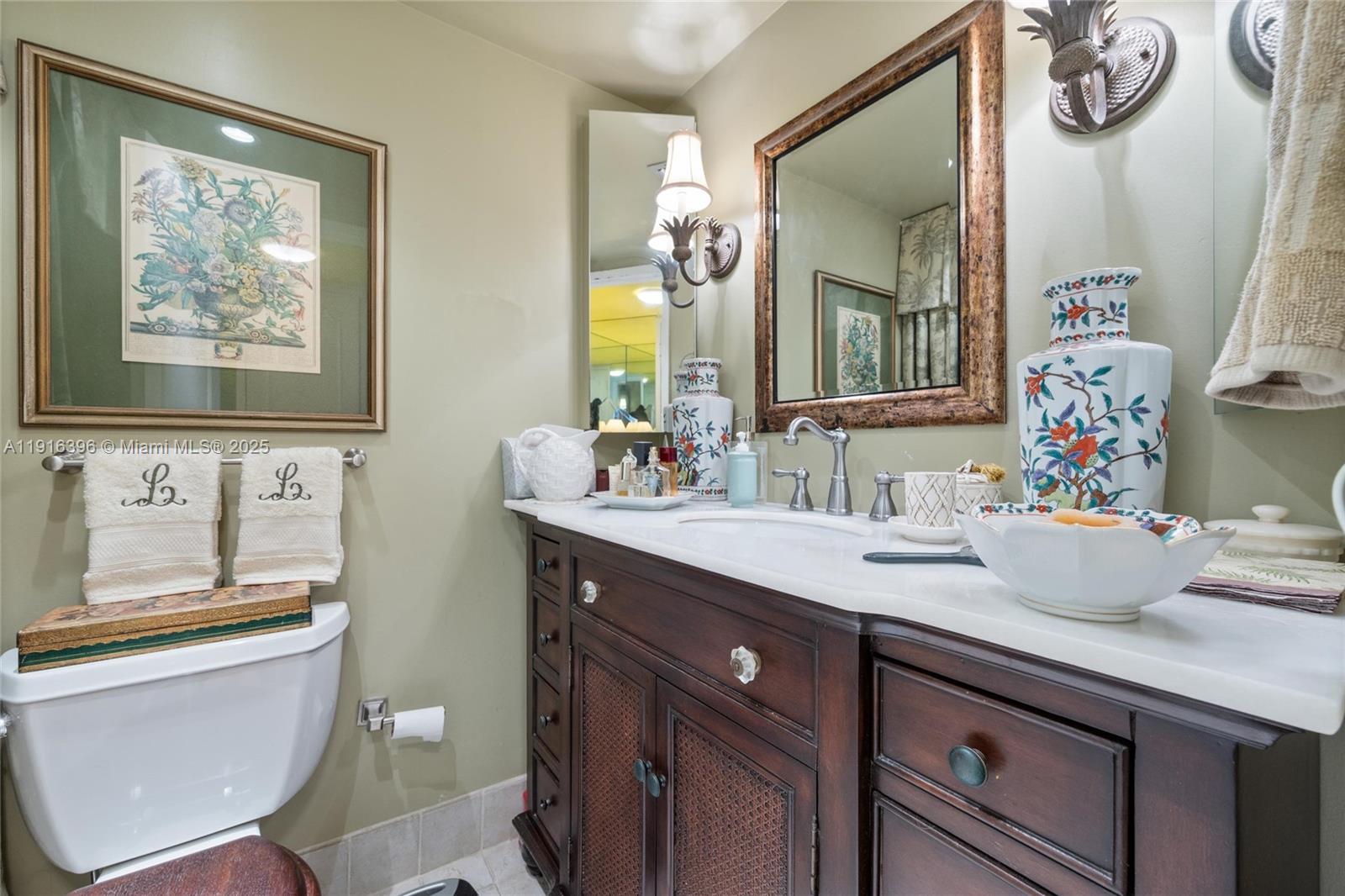 155 Sunrise Drive, Unit 4B Key Biscayne, FL 33149 - Photo 4 of 18 a bathroom with a sink and a mirror