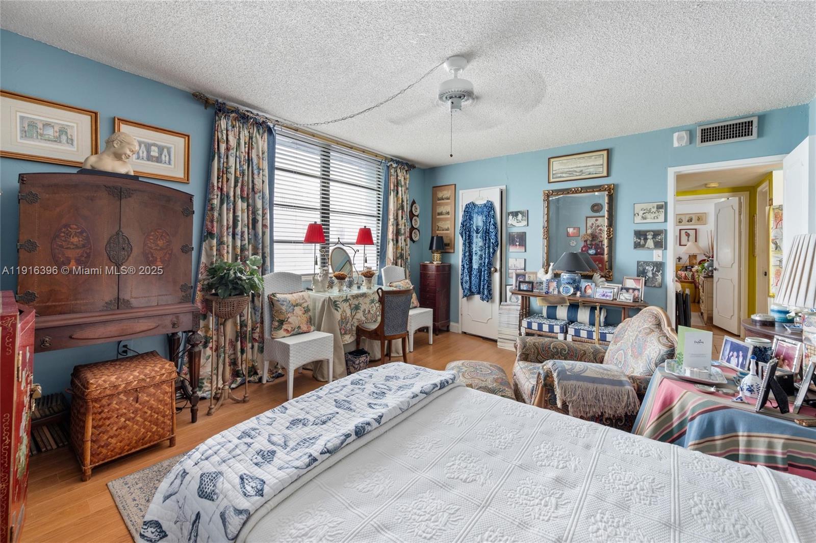 155 Sunrise Drive, Unit 4B Key Biscayne, FL 33149 - Photo 7 of 18 a bedroom with furniture and a fireplace