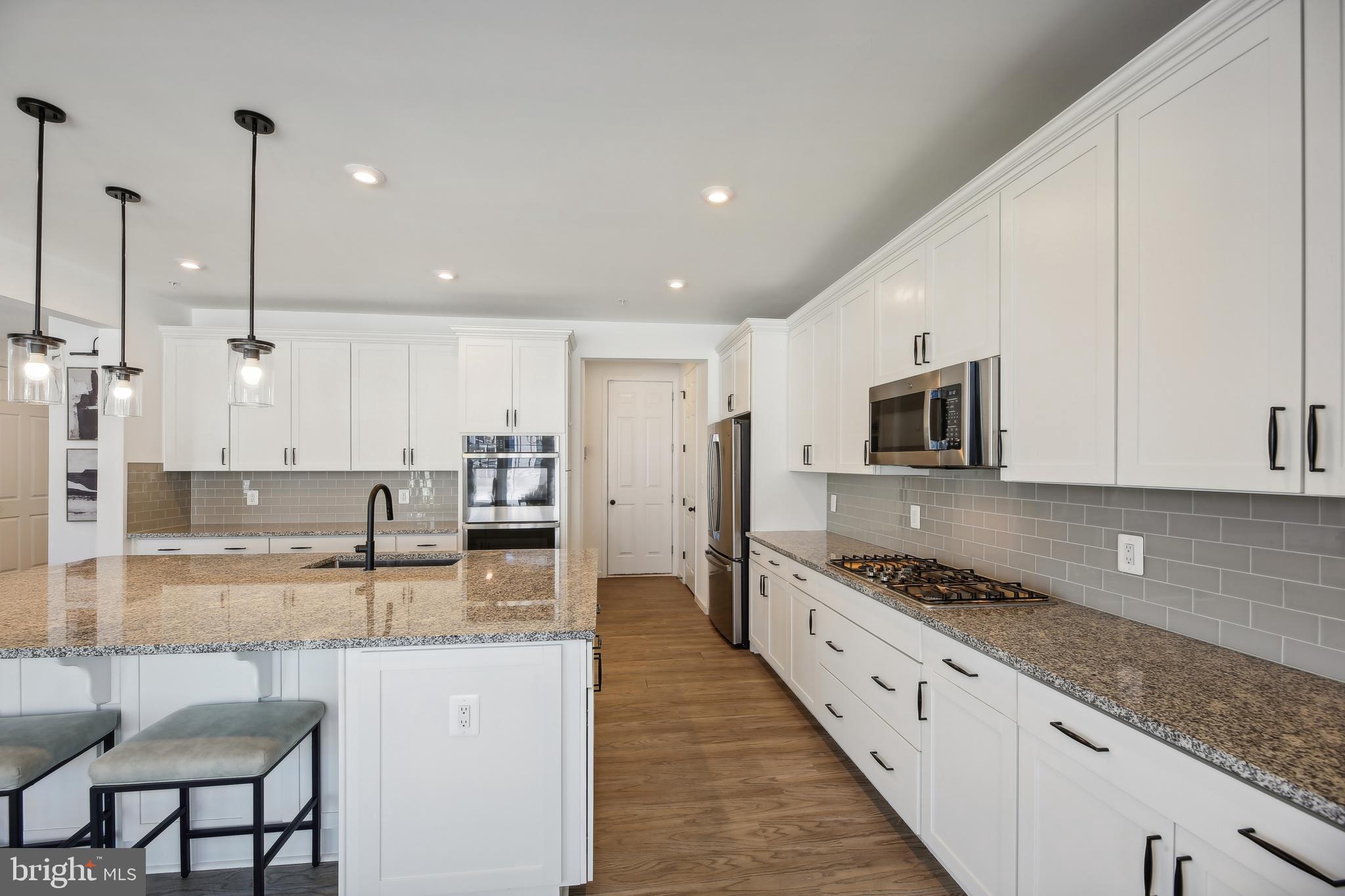 2634 Orchard Oriole Way Odenton, MD 21113 - Photo 16 of 63 a large kitchen with stainless steel appliances granite countertop a stove a sink and a granite counter tops