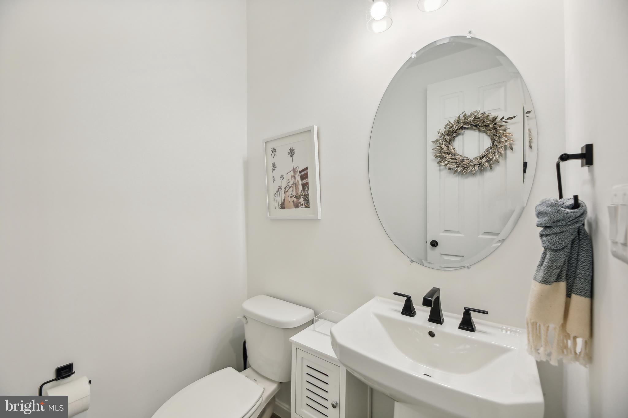 2634 Orchard Oriole Way Odenton, MD 21113 - Photo 20 of 63 a bathroom with a toilet sink and mirror