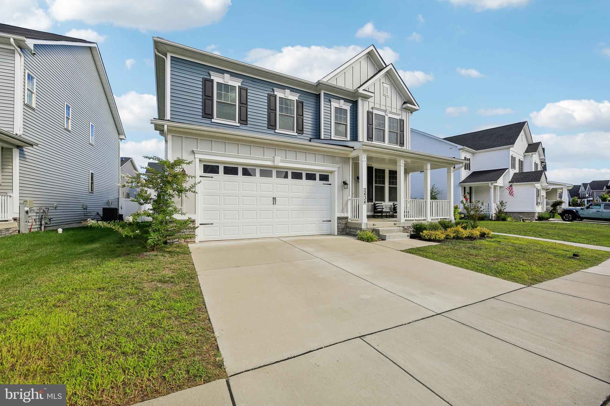 2634 Orchard Oriole Way Odenton, MD 21113 - Photo 2 of 63 a front view of a house with a yard and garage