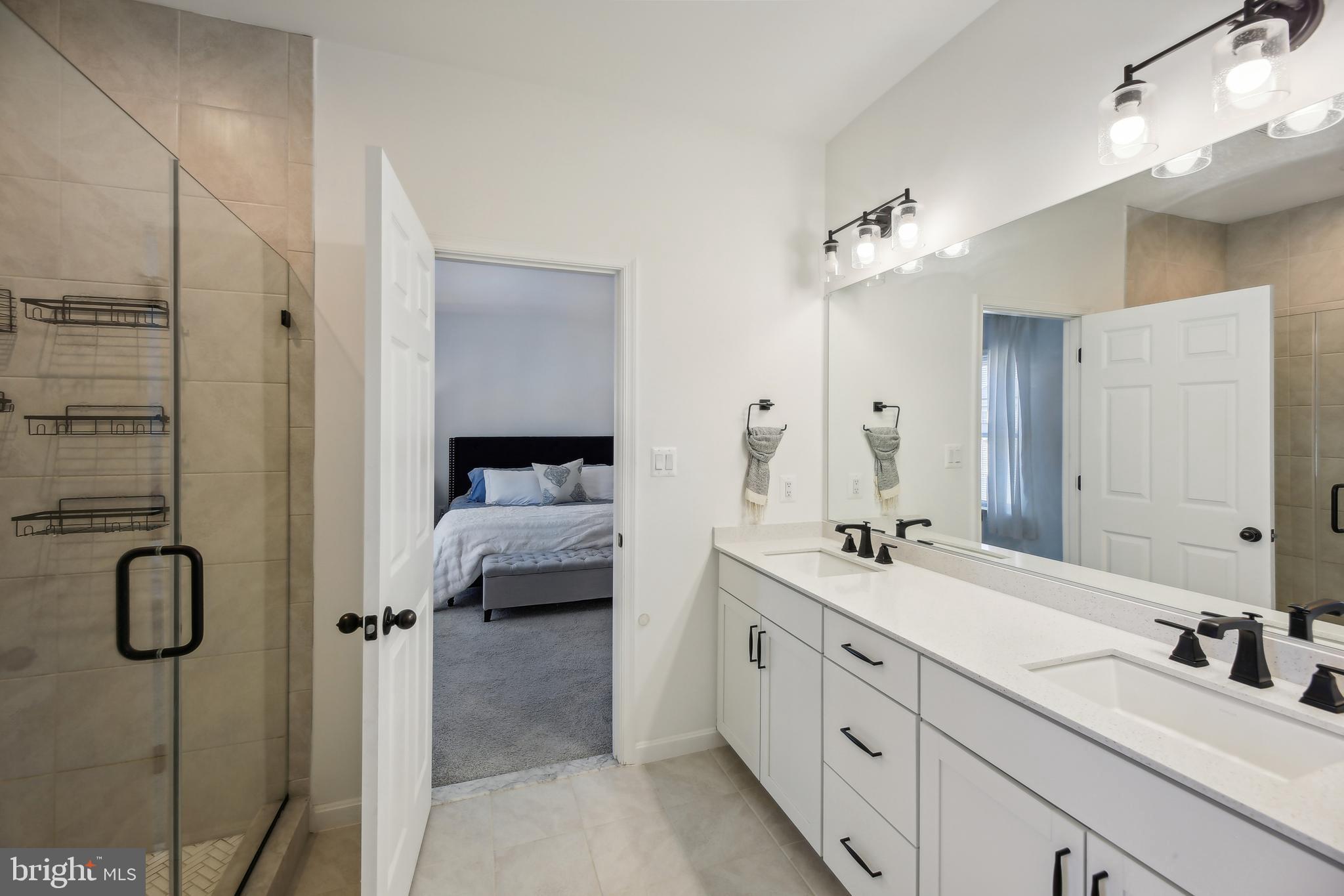 2634 Orchard Oriole Way Odenton, MD 21113 - Photo 23 of 63 a en suite bathroom with a double vanity sink tub and shower