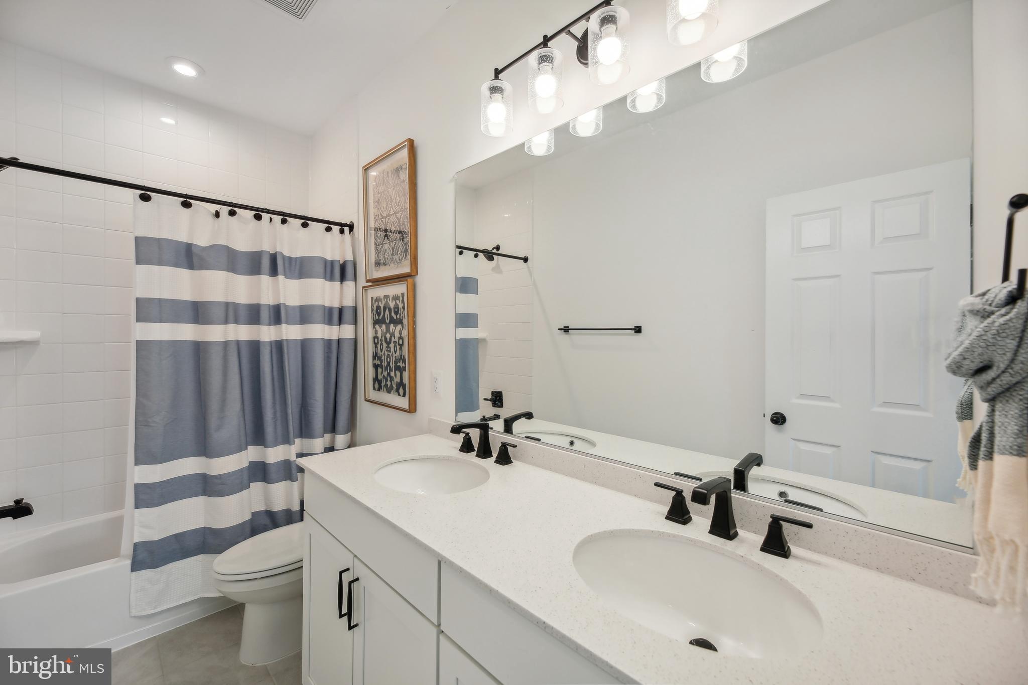 2634 Orchard Oriole Way Odenton, MD 21113 - Photo 25 of 63 a bathroom with a sink double vanity and a toilet