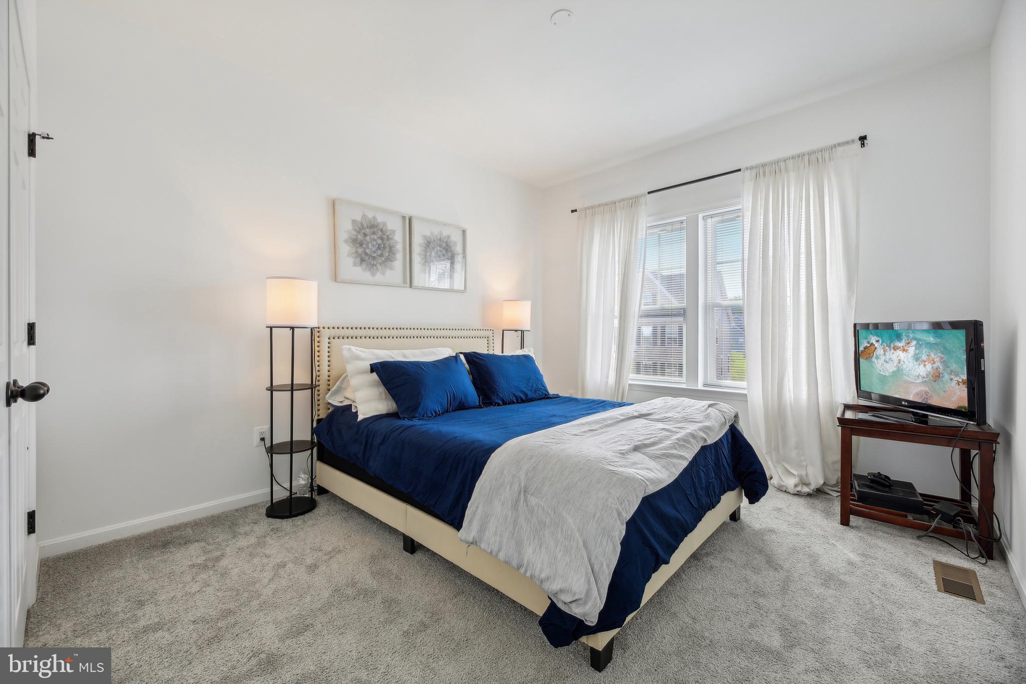 2634 Orchard Oriole Way Odenton, MD 21113 - Photo 32 of 63 a bedroom with a bed and a tv on table