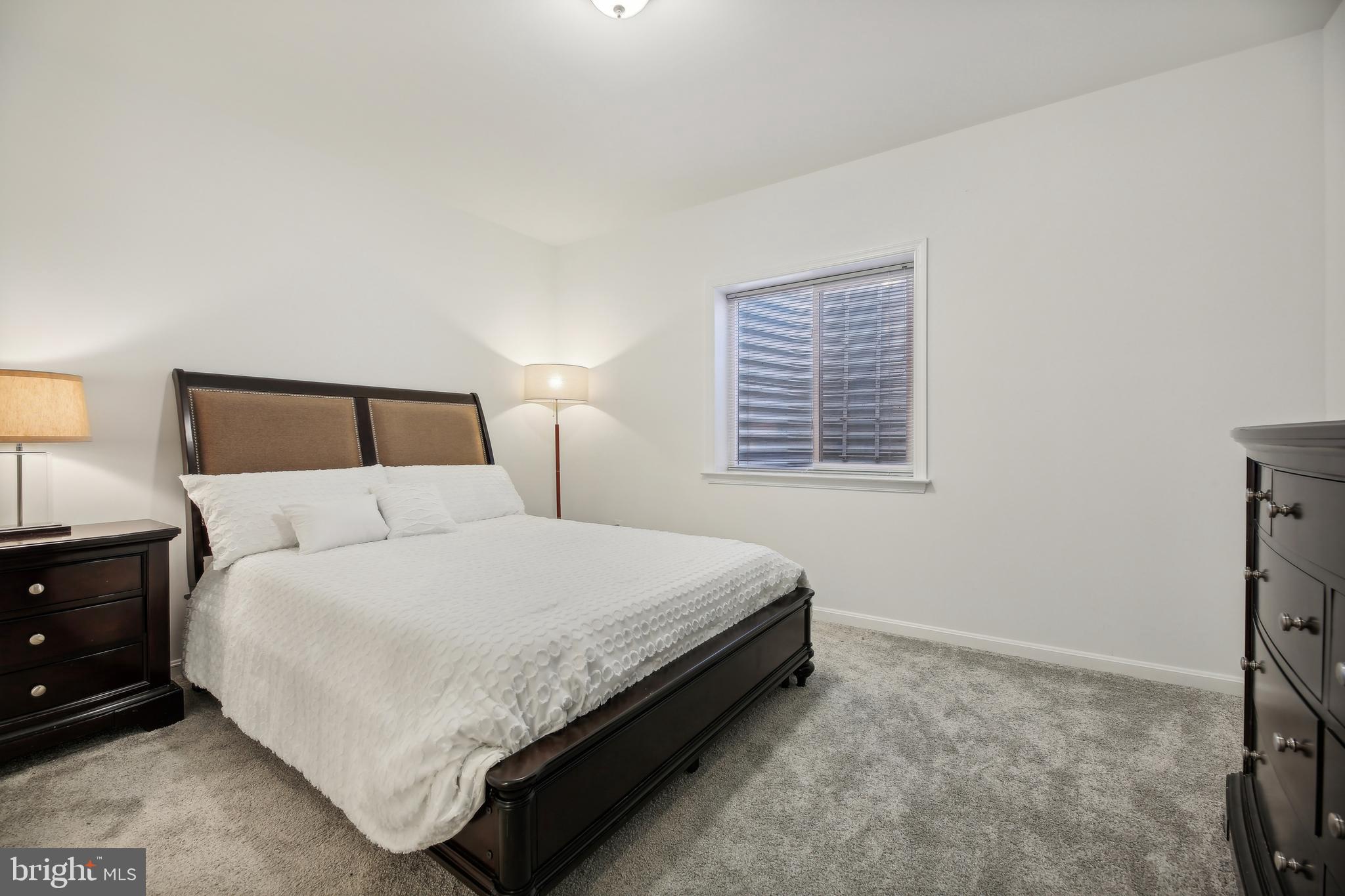 2634 Orchard Oriole Way Odenton, MD 21113 - Photo 37 of 63 a large bed sitting in a bedroom next to a window