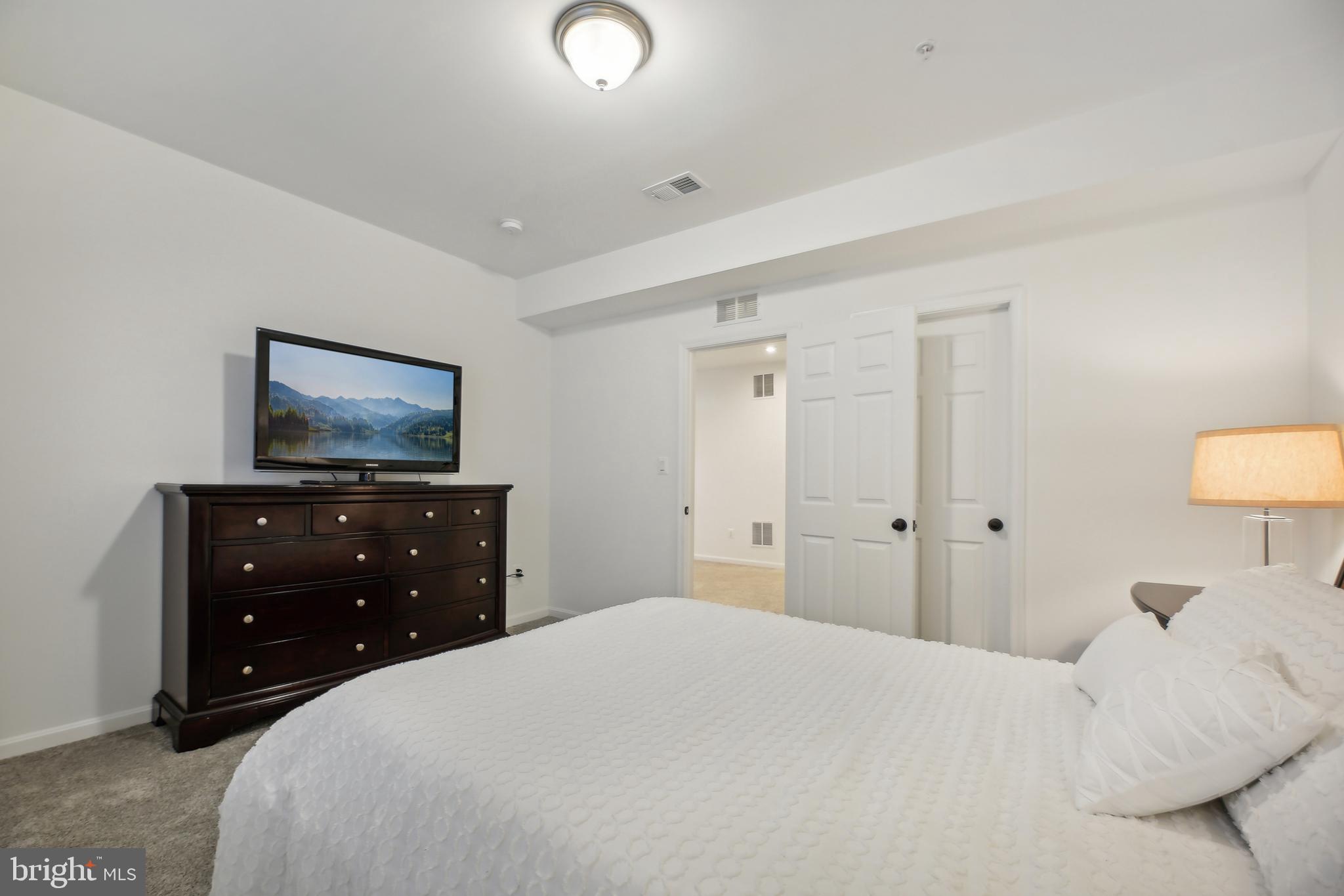 2634 Orchard Oriole Way Odenton, MD 21113 - Photo 38 of 63 a bedroom with a bed and a flat screen tv