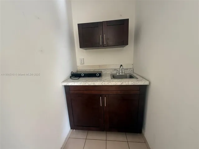 a kitchen with a sink and a stove top oven