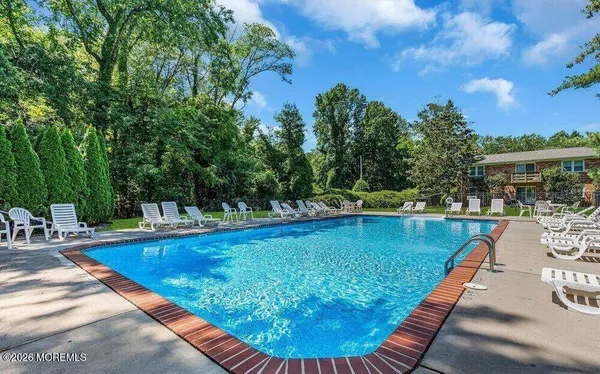 a view of a swimming pool with lounge chair