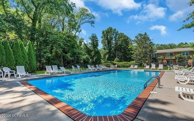 a view of a swimming pool with lounge chair