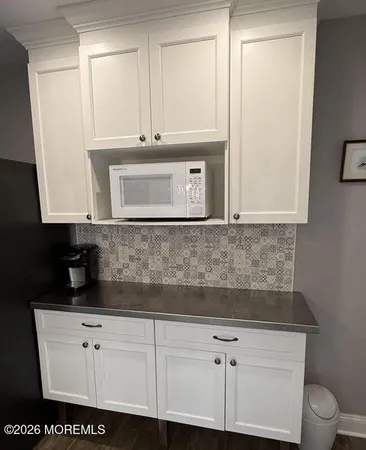 a kitchen with stainless steel appliances white cabinets and a sink