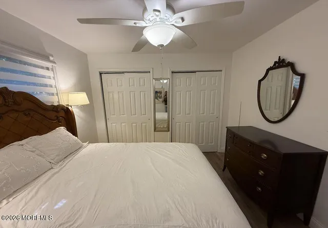 a bedroom with a bed and a mirror