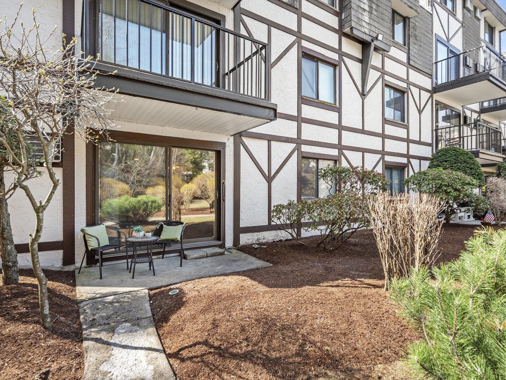9 Broadway, Unit 110 Saugus, MA 01906 - Photo 1 of 27 a building outdoor space with patio furniture and potted plants
