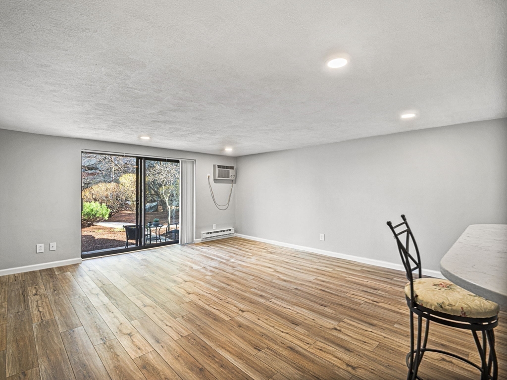 9 Broadway, Unit 110 Saugus, MA 01906 - Photo 11 of 27 a view of a livingroom with furniture and a window