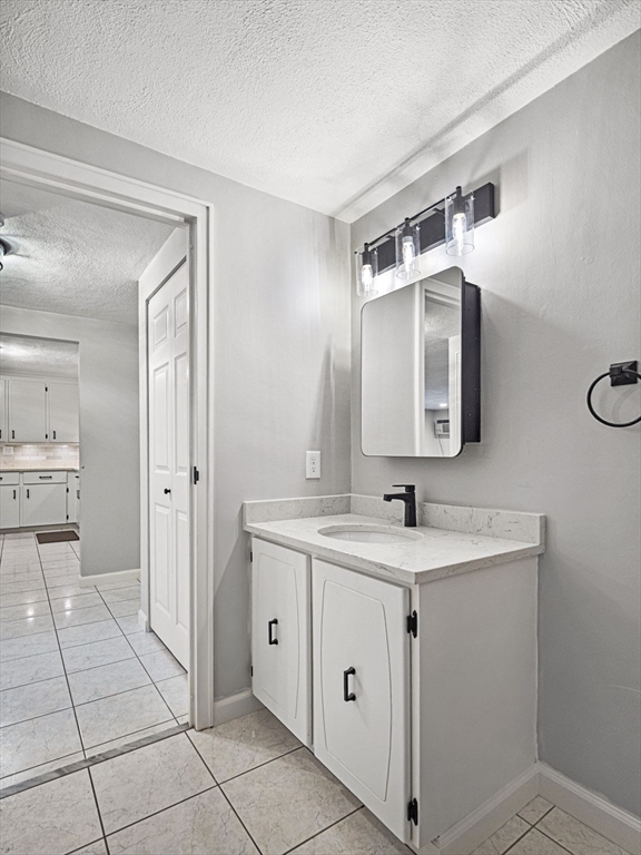 9 Broadway, Unit 110 Saugus, MA 01906 - Photo 14 of 27 a bathroom with a sink and a mirror