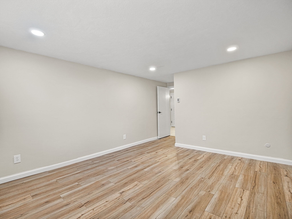 9 Broadway, Unit 110 Saugus, MA 01906 - Photo 17 of 27 a view of an empty room with wooden floor
