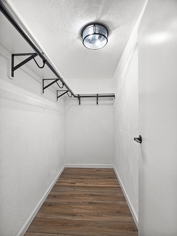 9 Broadway, Unit 110 Saugus, MA 01906 - Photo 18 of 27 a view of a room with wooden floor and white walls