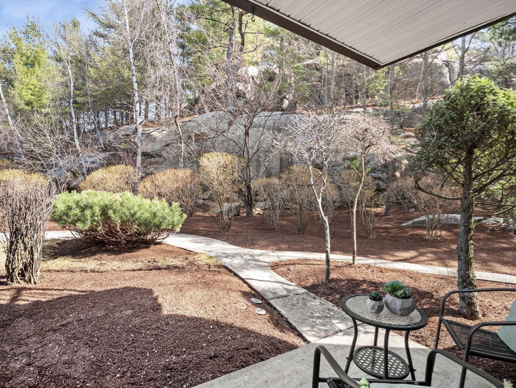 9 Broadway, Unit 110 Saugus, MA 01906 - Photo 20 of 27 a backyard of a house with table and chairs