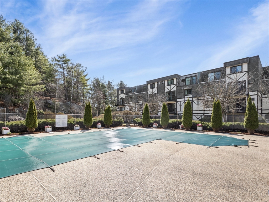 9 Broadway, Unit 110 Saugus, MA 01906 - Photo 25 of 27 a view of a building with a yard