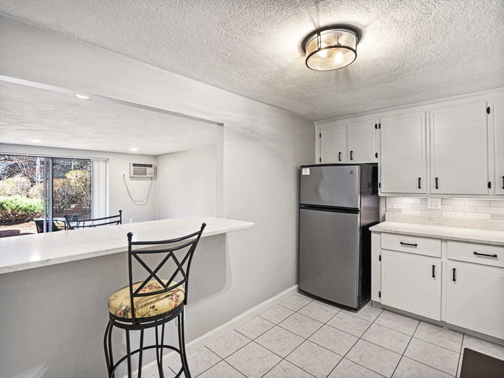 9 Broadway, Unit 110 Saugus, MA 01906 - Photo 8 of 27 a kitchen with furniture a refrigerator and a sink