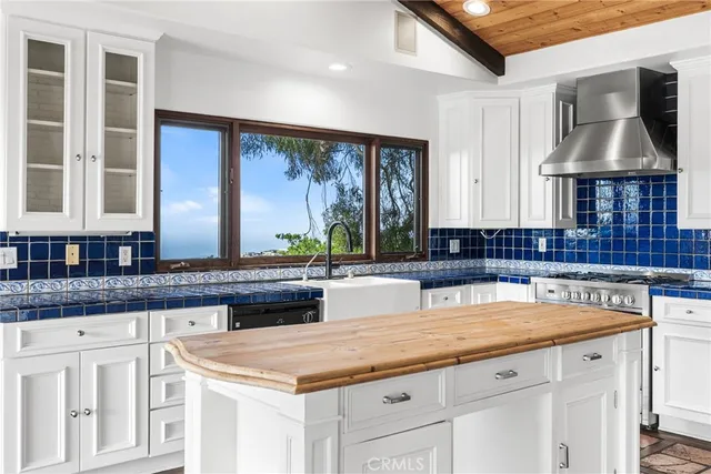 a kitchen with granite countertop a sink a counter space and cabinets