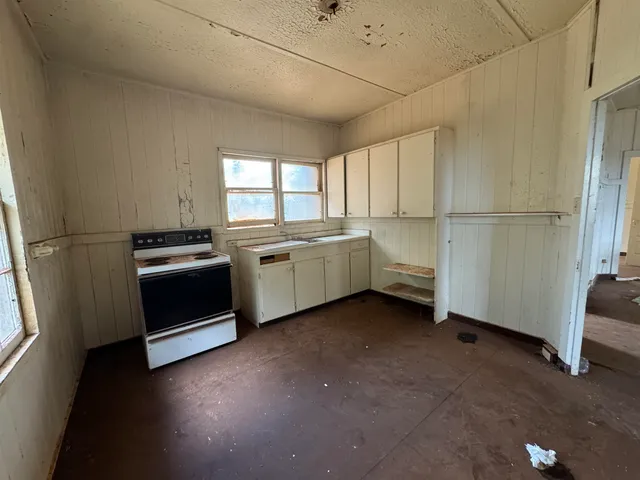 a kitchen that has a sink and a stove top oven